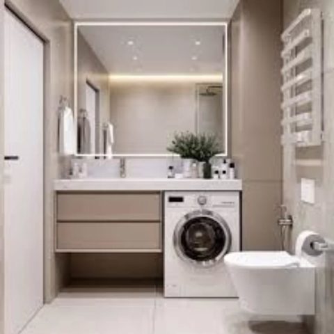 Bej lavabo dolabı ve tezgah, ışıklı ayna, çamaşır makinesi nişi ve asma klozetli banyo